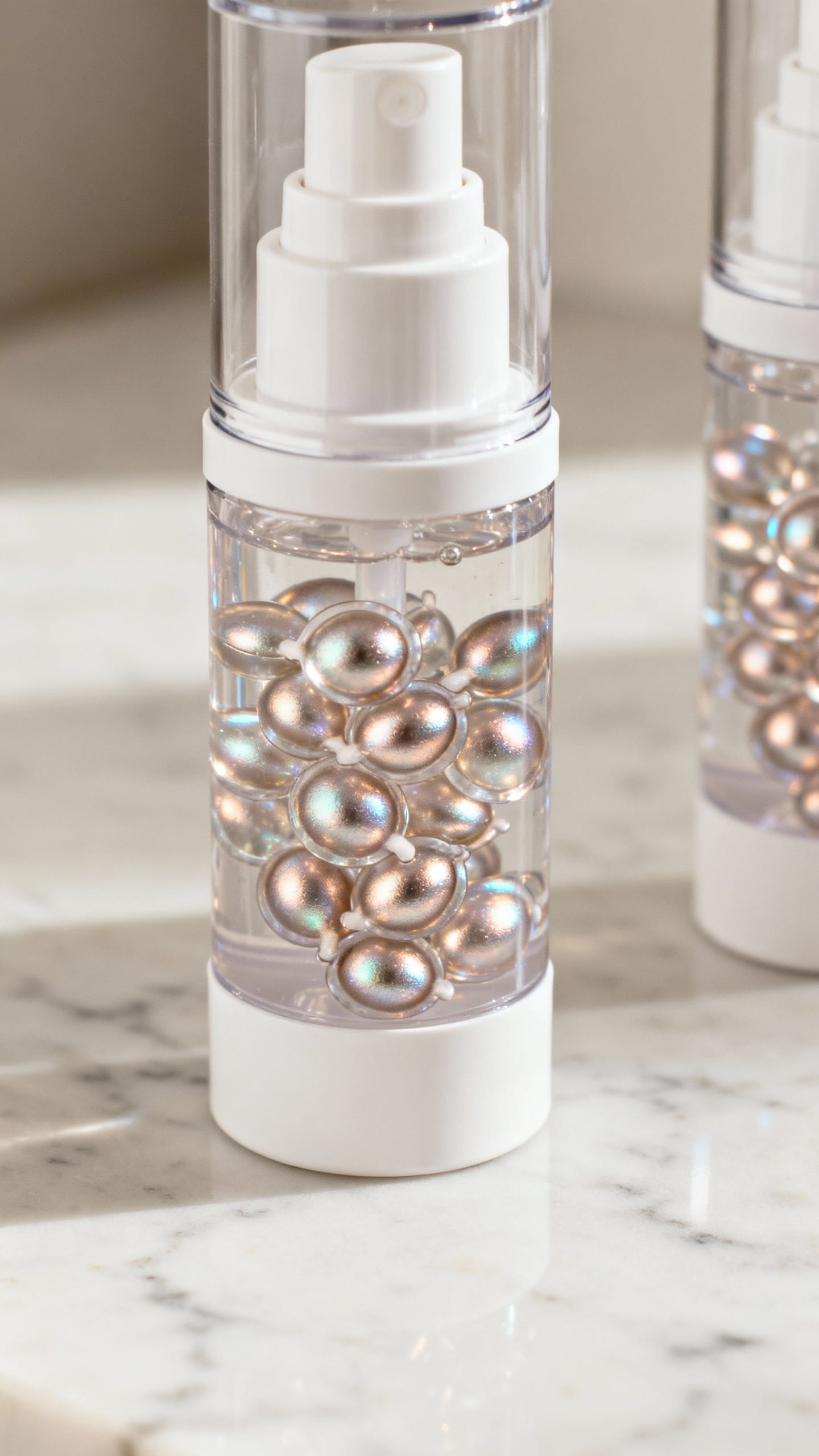 Opaque airless pump bottles on marble counter, hyaluronic gel beads shimmering